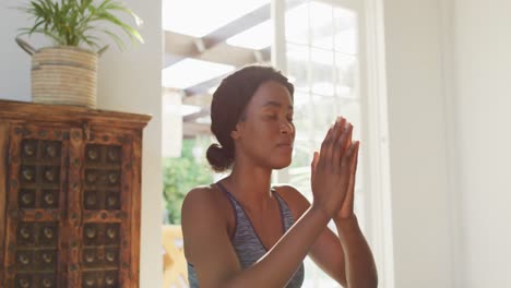video of relaxed african american woman practicing yoga at home