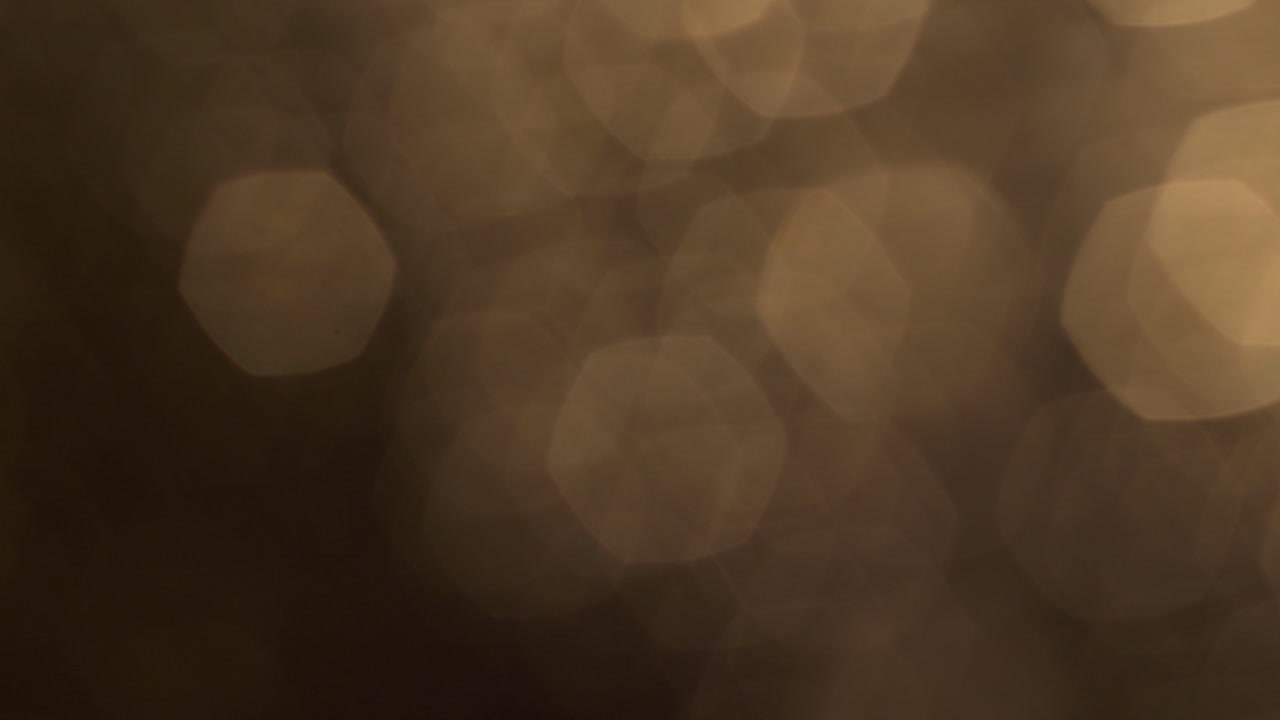 Luci Bokeh Esagonali Dorate Calde Scintillanti