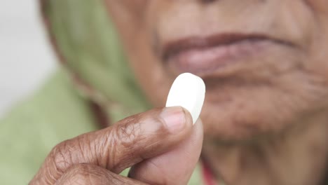 elderly woman taking medicine