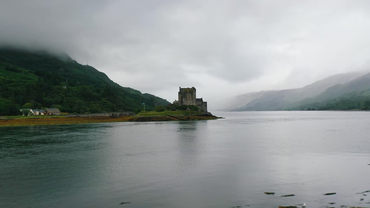 revelación aérea baja del castillo de eilean donan en el lago duich en las tierras altas de escocia - paisaje escocés