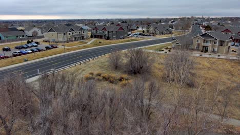 a unique drone shot flys through a gazebo and over trees to reveal the neighborhood surrounding and urban park. greeley colorado winter.