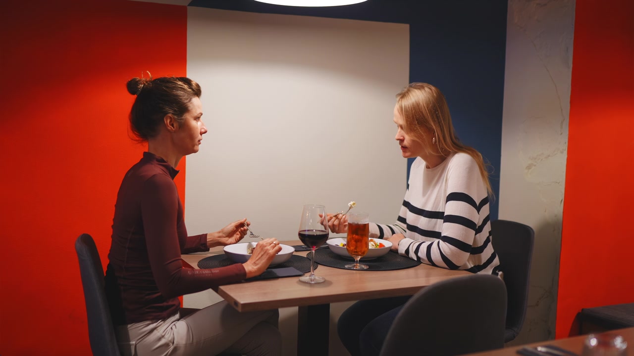 Two Women Enjoying Dinner at Restaurant