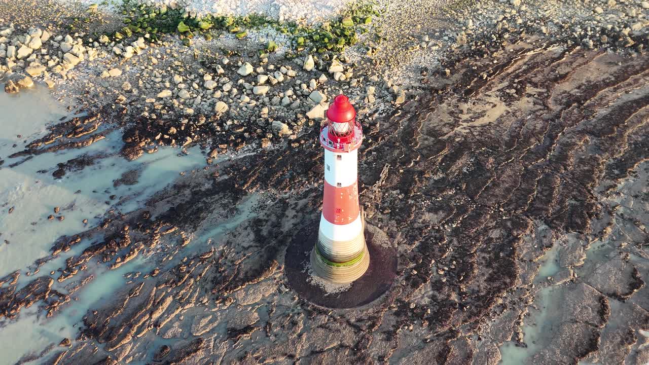 Aerial footage of Beachy Head Lighthouse and stunning rocky coastline in Sussex, England. Epic coastal views, dramatic shoreline and ocean. Perfect for travel, nature, and landscape projects.