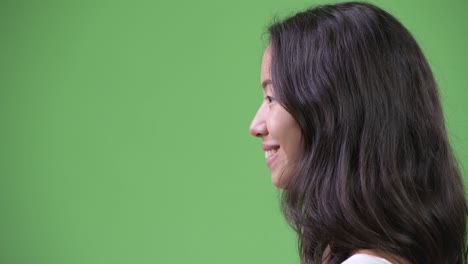 closeup profile view of happy young beautiful multi-ethnic woman smiling