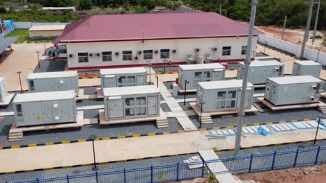 Aerial View of a Modern Energy Facility with Solar Panels and Containerized Power Units