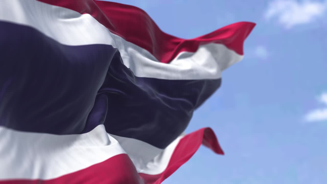 Detail of the national flag of Thailand waving in the wind on a clear day