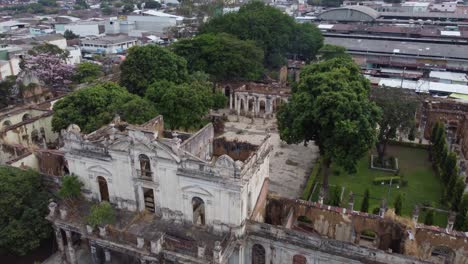 Aerial-retreats-from-historical-old-building-facade-in-Santa-Ana,-SLV