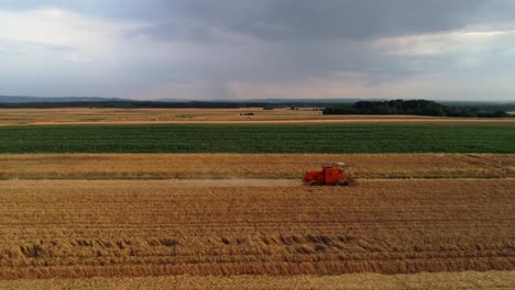 drone view of modern combine harvester during harvesting