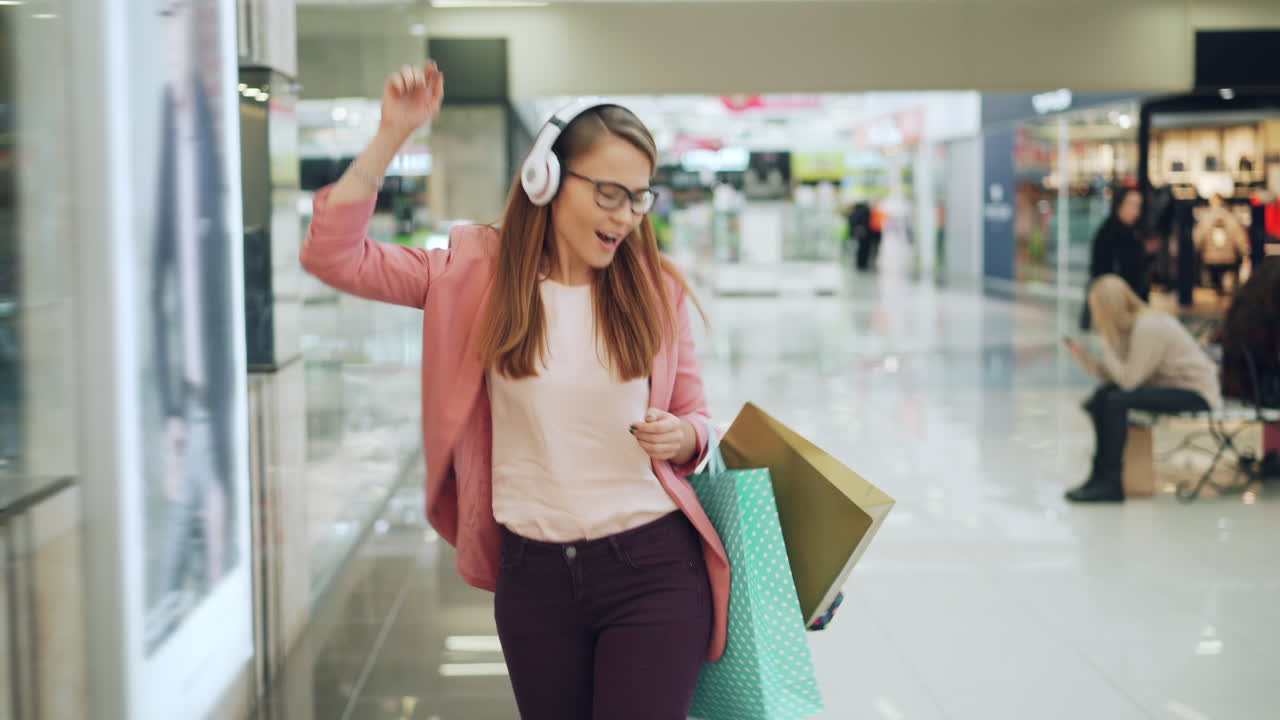 Woman Dancing and Shopping in a Mall
