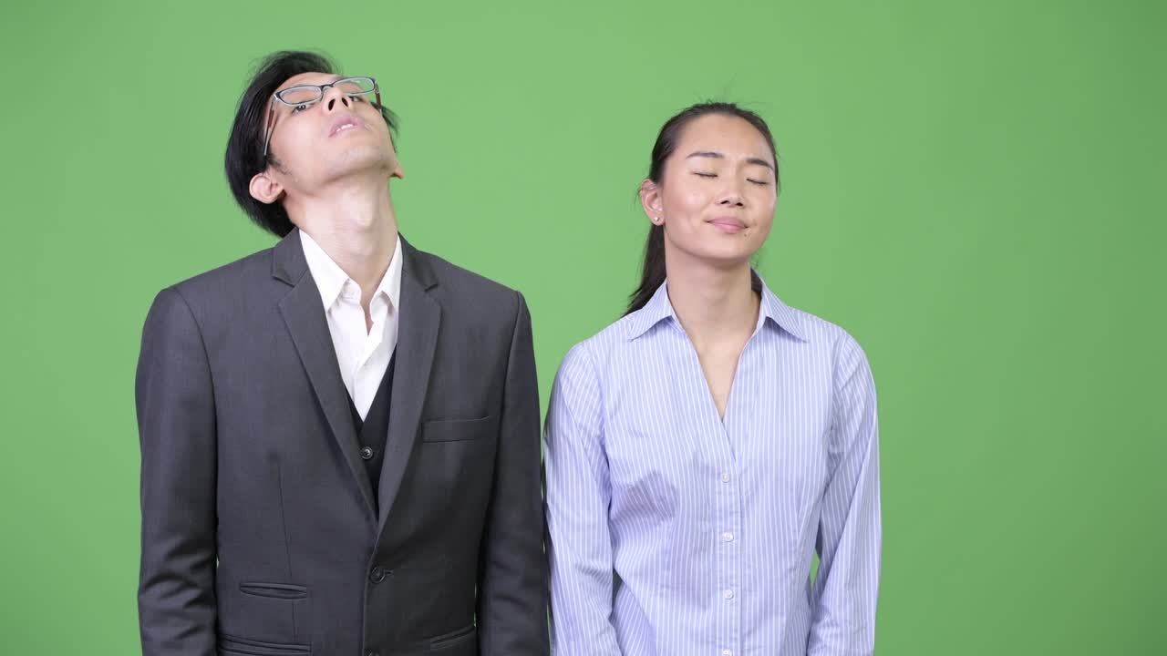 Young Asian business couple getting bad news together