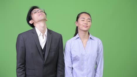 young asian business couple getting bad news together