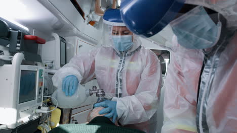 paramedics providing emergency respiratory support in an ambulance