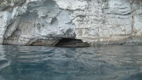 snorkeler emerged out of crystal blue water of ionian sea at jerusalem beach in kefalonia, greece