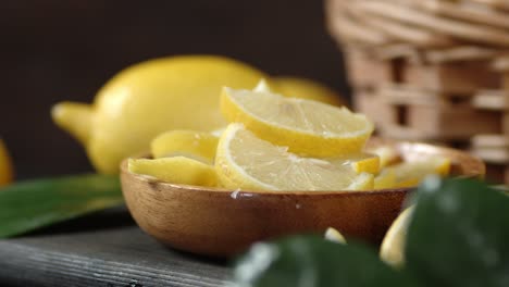 sliced lemon in a bowl on a cutting board rotates slowly.