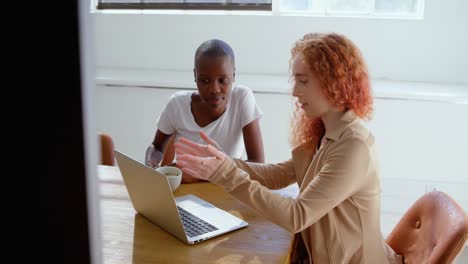 Front view of young mixed-race business team working on digital tablet in a modern office 4k