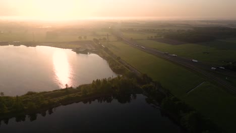 sunrise over a lake and highway