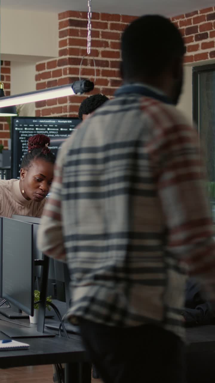 Team of developers collaborating on software code in a modern office