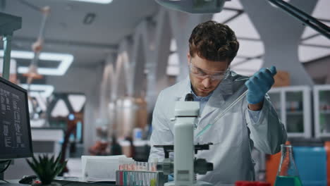 young microbiologist experimenting medicines in clinic laboratory close up.