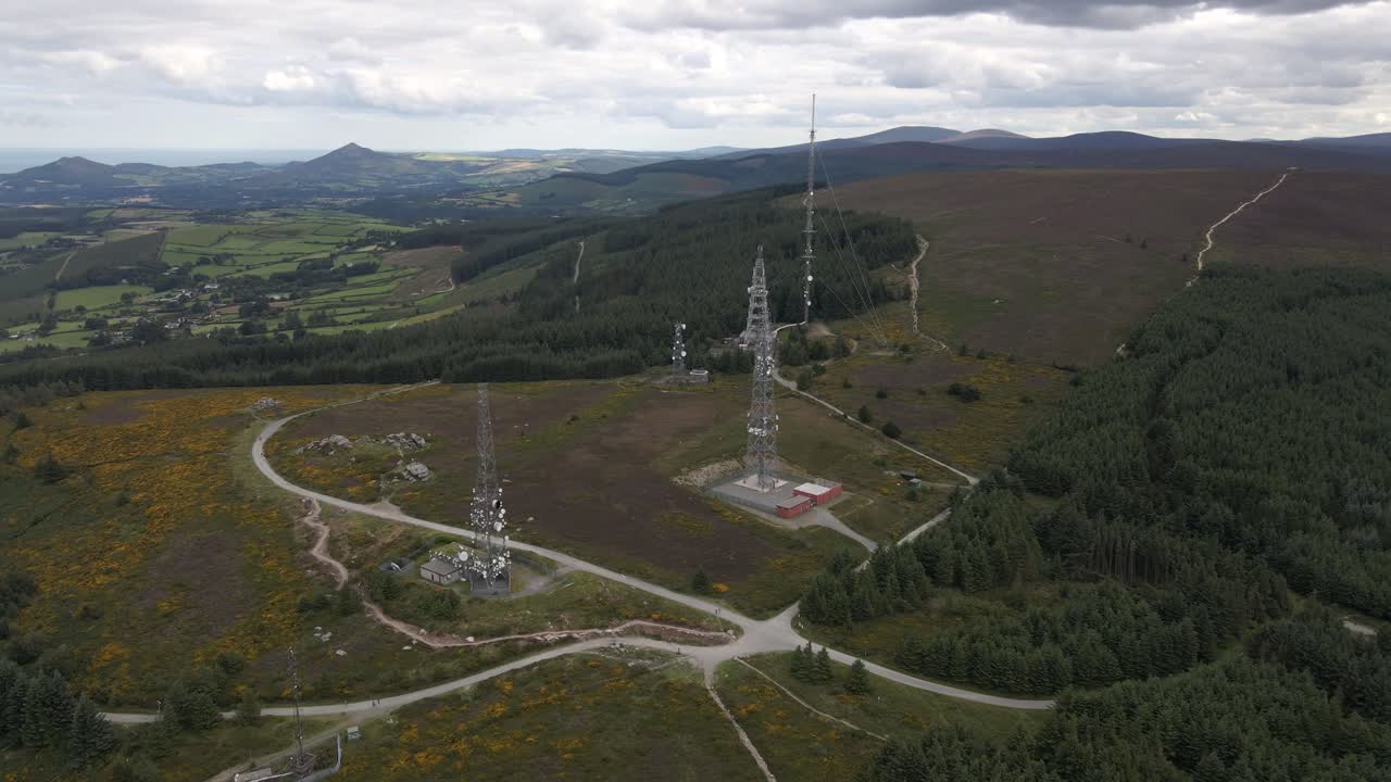 Drone shot of radio masts on top of a mountain.