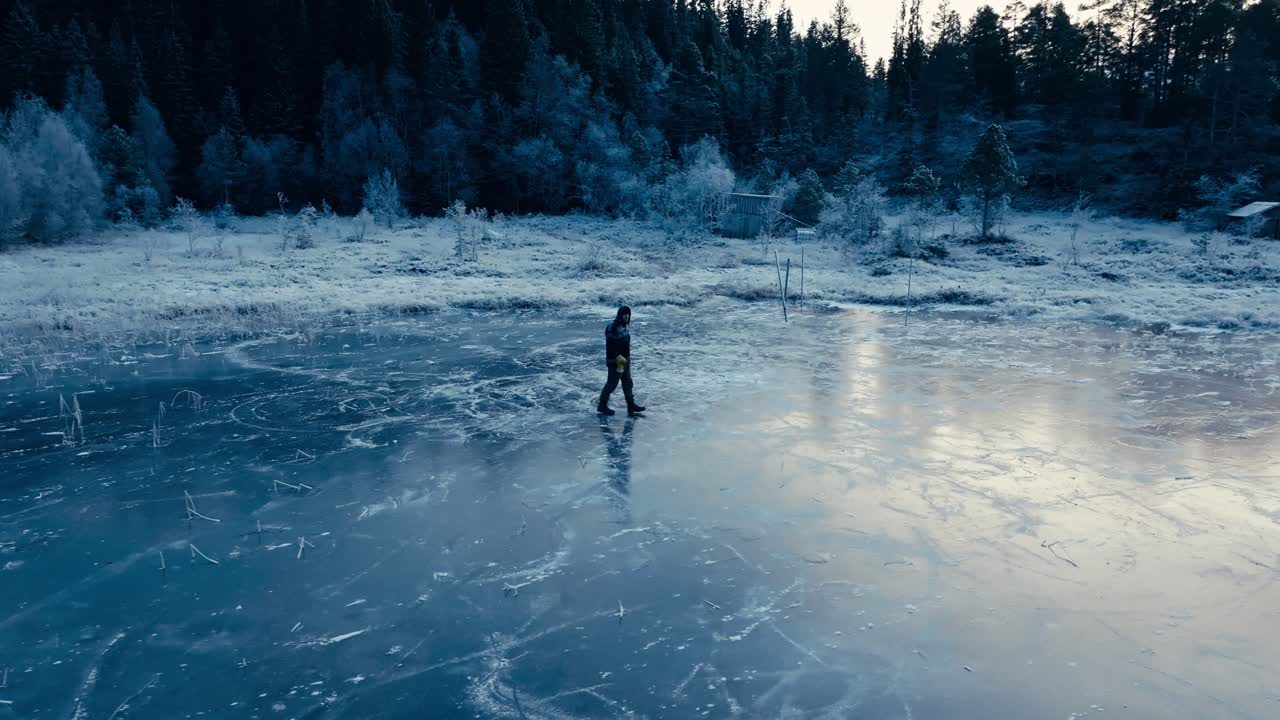 Indre Fosen, Trondelag County, Norway - A Man Walking on the Lake's Snow-covered Surface of Omundvatnet - Orbit Drone Shot