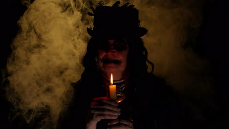 Frightening-creepy-senior-woman-with-Halloween-witch-makeup-looking-at-candle,-conjure,-hex,-wiz