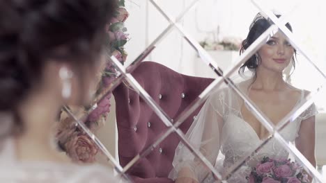 lady-in-large-red-armchair-looks-into-mirror-slow-motion