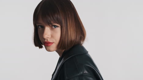 young female model in black leather jacket posing