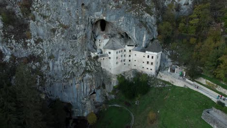 primer plano aéreo con movimiento circular si predjama castel, slavenia