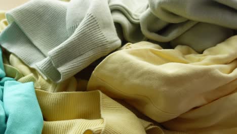 close-up of a pile of yellow and green shirts