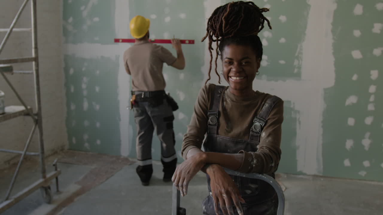 Construction Workers Repairing Wall