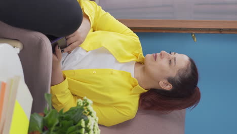 Vertical-video-of-Woman-smiling-at-phone-message.