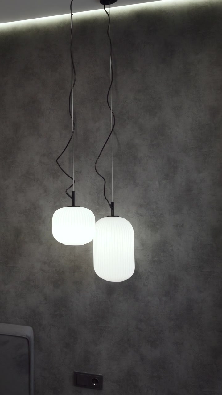 Moody Bedroom With Pendant Lights, Ribbed Plaster Accent Wall And Upholstered Headboard, Suspended Globe Lamps