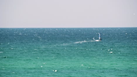 windsurfer on turquoise ocean