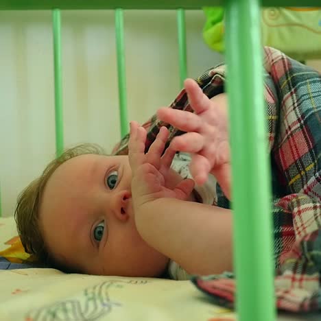 beautiful baby lying awake in crib