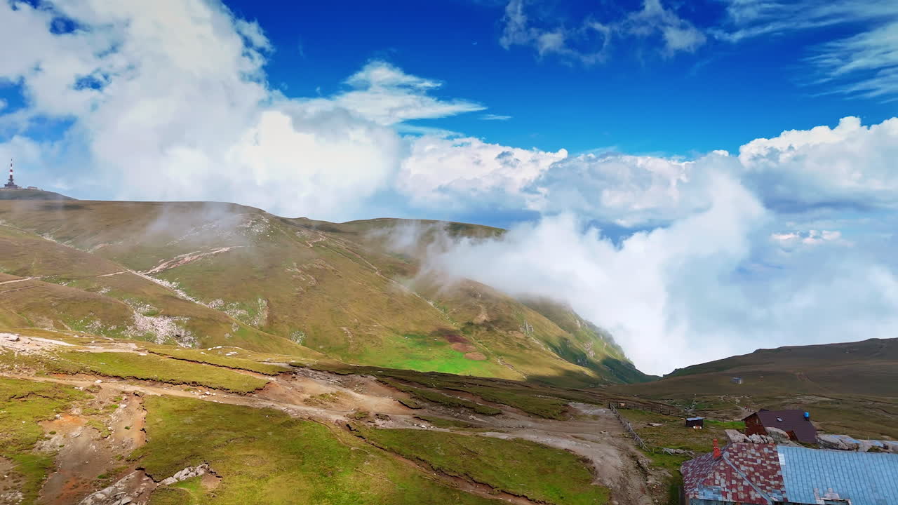 Alpine plateau landscape of Caraiman Mountain. The Caraiman Plateau shows a mix of grassy meadows and rocky outcrops in Bucegi Mountains, Romania