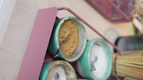 vertical, raw sugar in trendy earthenware bowls at coffee shop with silver spoon