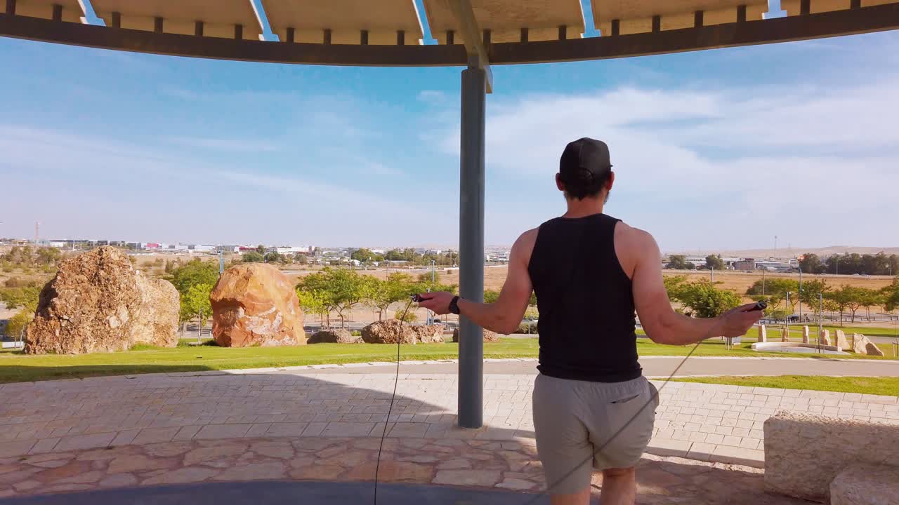 Young men jumping rope in a park
