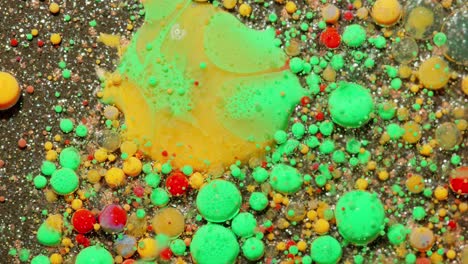 abstract green, yellow, and red fluid art with glitter