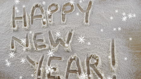 snowflakes falling against happy new year text written in snow