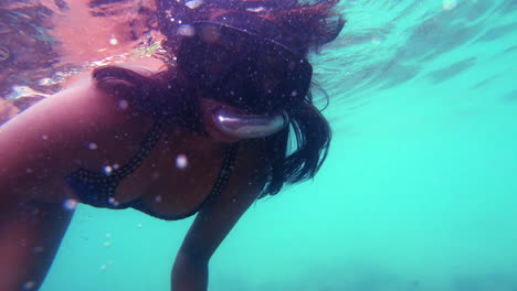 slow motion | indian girl snorkeling - swimming looking for tropical fish