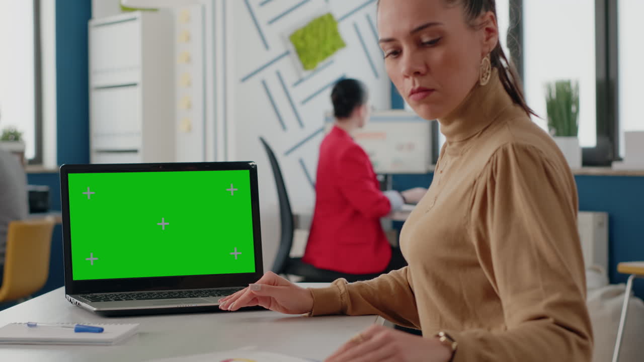 Close up of woman using green screen on laptop