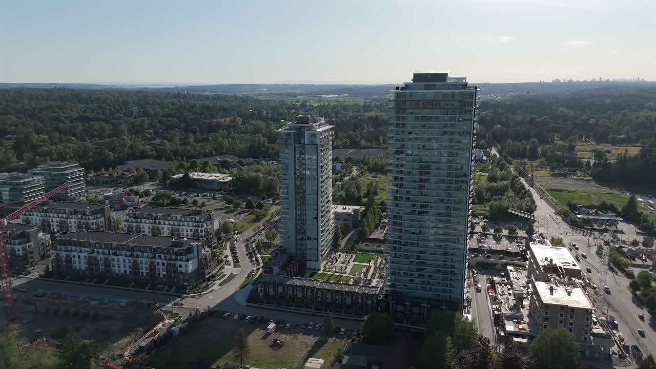 Construction Site Near Towering Residential Buildings At Sunrise In Langley City, British Columbia, Canada. Aerial Drone Shot