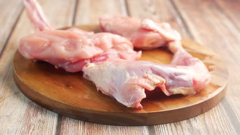 raw chicken pieces on a cutting board