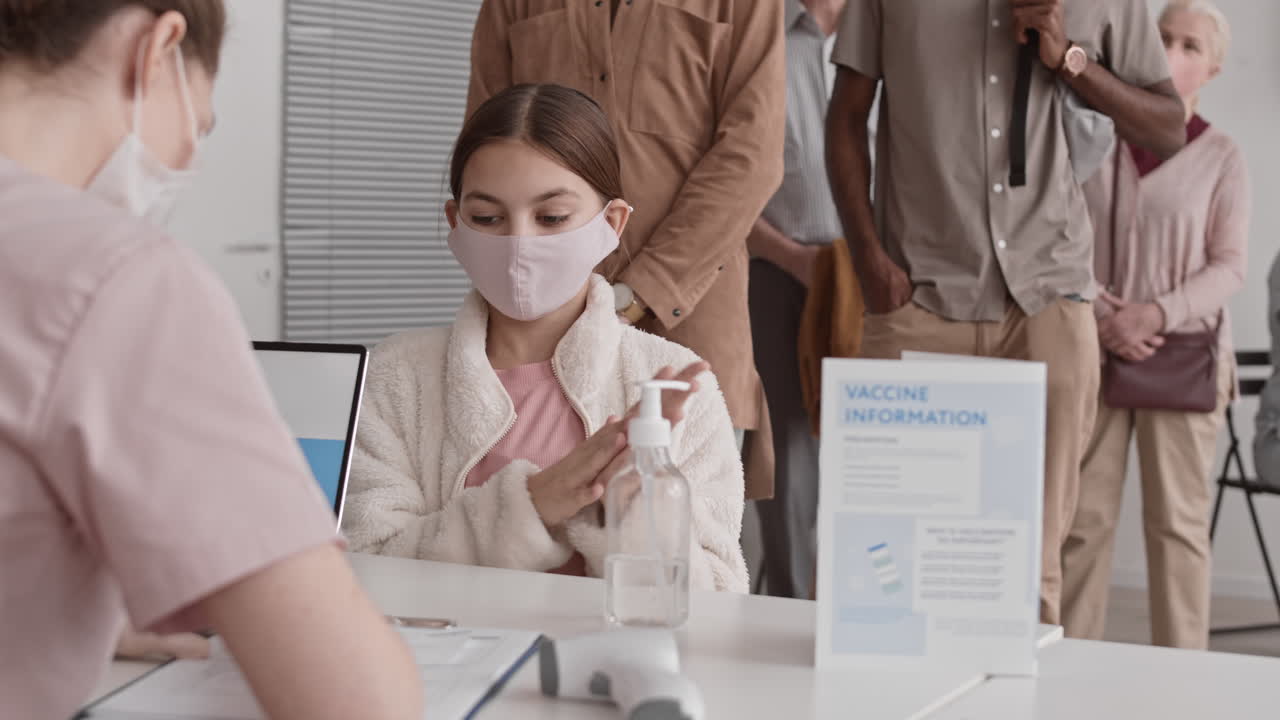 People Using Hand Sanitizer in Hospital