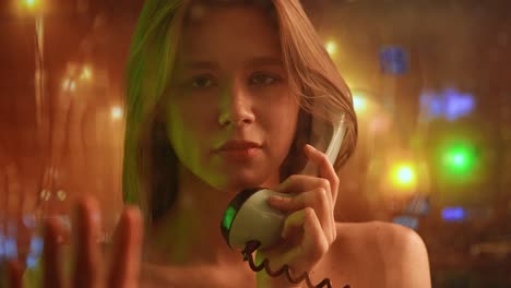 close-up portrait of a young woman on a phone call at night with blurred city lights