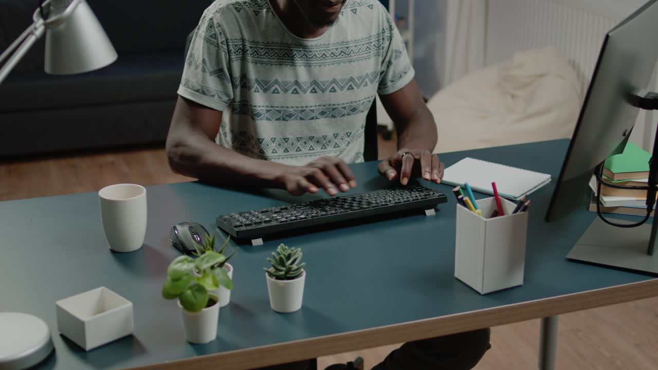 Close up of african american hands typing on computer keyboard