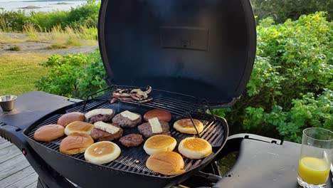 homemade burgers on the grill with halloumi and buns