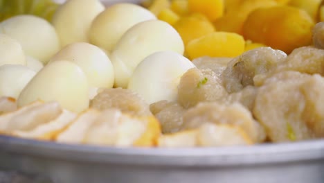 steamed potatoes, tofu and eggs steaming in a steam pot - indonesian street food called siomay