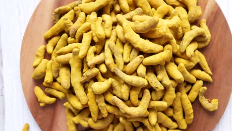 detail shot of turmeric root in bowl on table