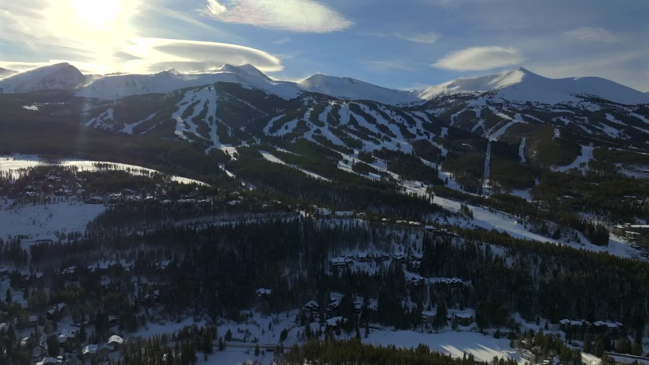 Sunset Breckenridge Ski Resort mountain town Colorado aerial drone Winter December January skiing trails run Peak 9 10 Ten Mile Range Epic Vail Pass cirrus clouds chairlifts forward pan right motion